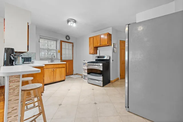 a kitchen with a stove a sink and a refrigerator