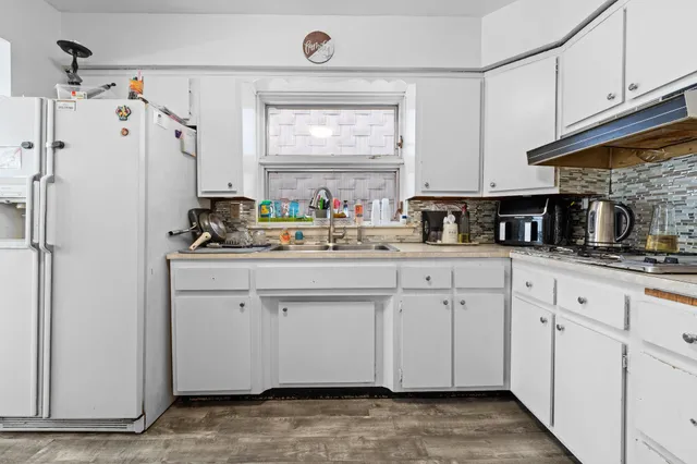 a large bathroom with a tub sink and mirror