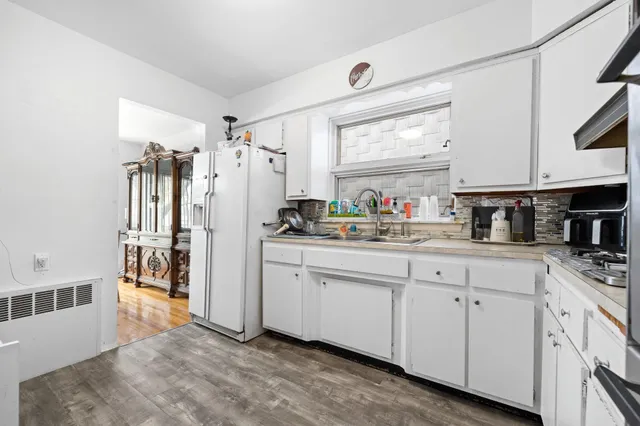 a kitchen with white cabinets and white appliances