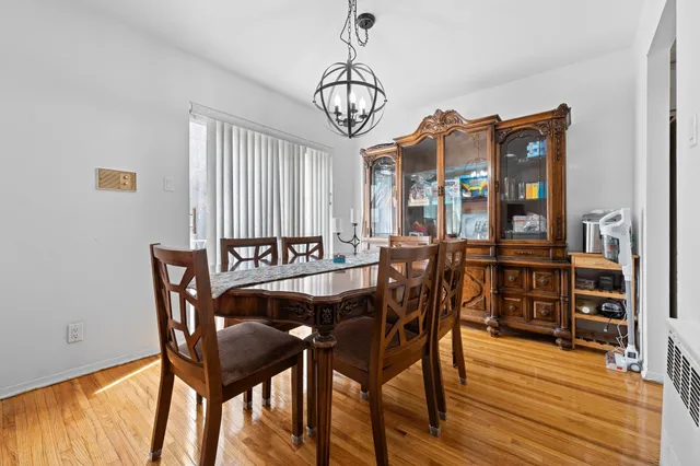 a kitchen with white cabinets and refrigerator