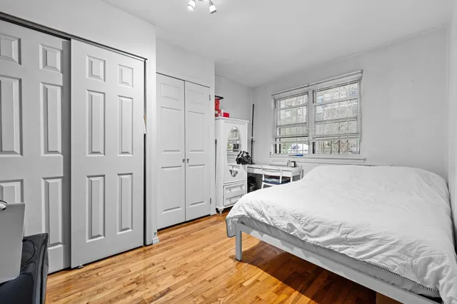 a bedroom with a bed and flat screen tv