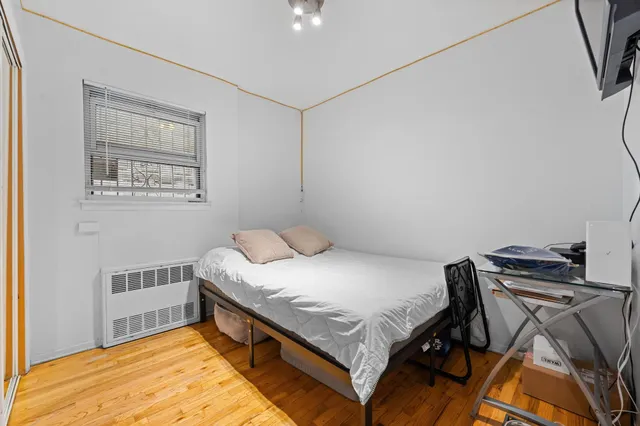 a bedroom with a bed closet and a window