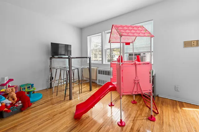 a bedroom with furniture and a wooden floor