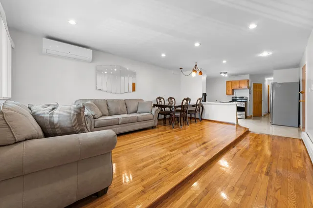 a living room with furniture and kitchen view