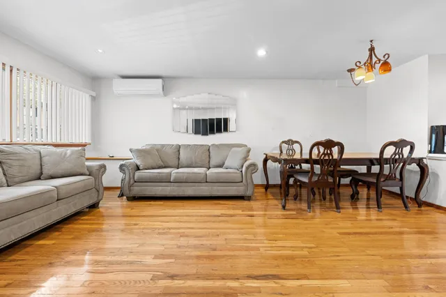 a living room with furniture and a view of kitchen