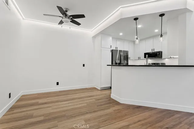 a view of kitchen with wooden floor and window