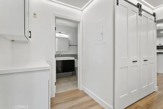 a view of walk in closet with wooden floor
