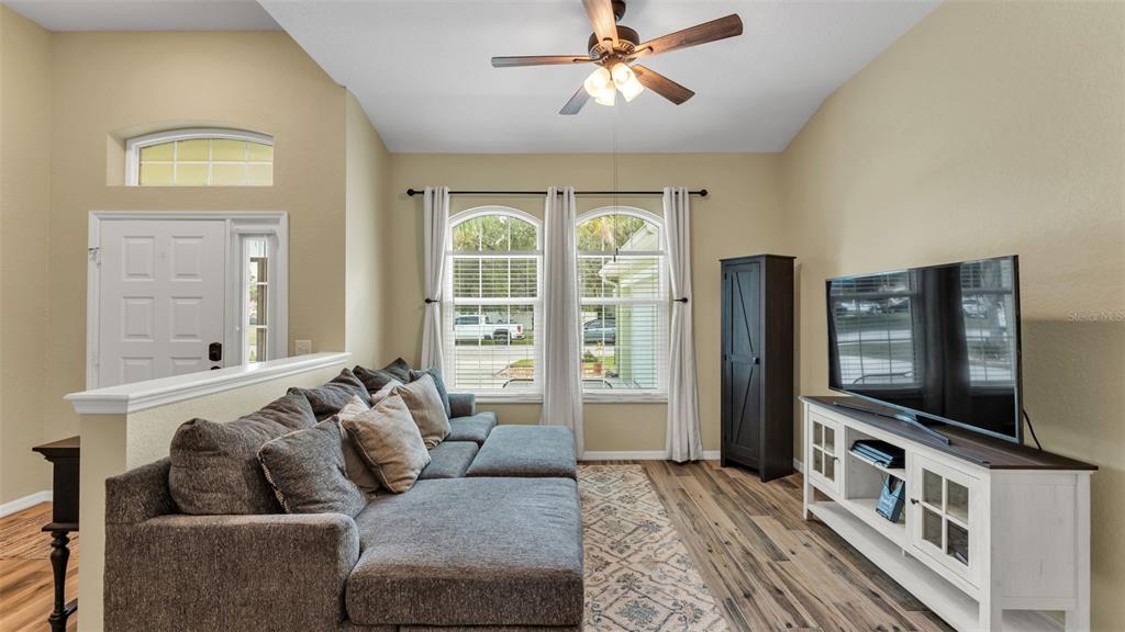 2803 Spring Meadow Drive Plant City, FL 33566 - Photo 11 of 74 a living room with furniture and a flat screen tv