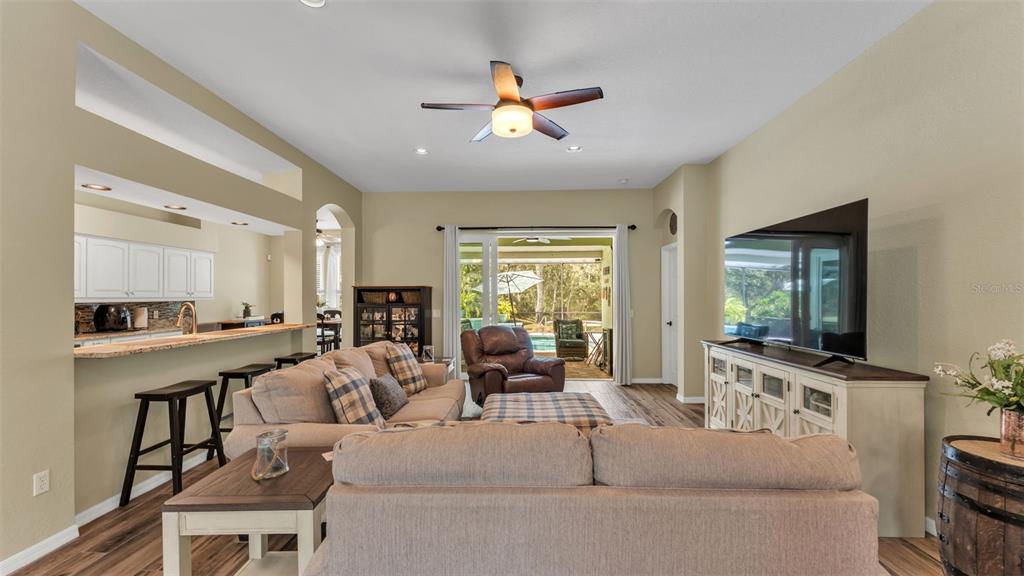 2803 Spring Meadow Drive Plant City, FL 33566 - Photo 13 of 74 a living room with furniture a flat screen tv and a large window