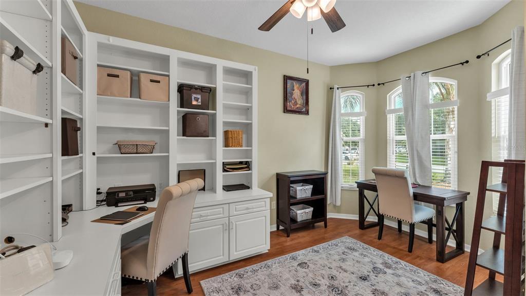 2803 Spring Meadow Drive Plant City, FL 33566 - Photo 26 of 74 a kitchen with stainless steel appliances granite countertop a stove top oven a sink a dining table and chairs with wooden floor