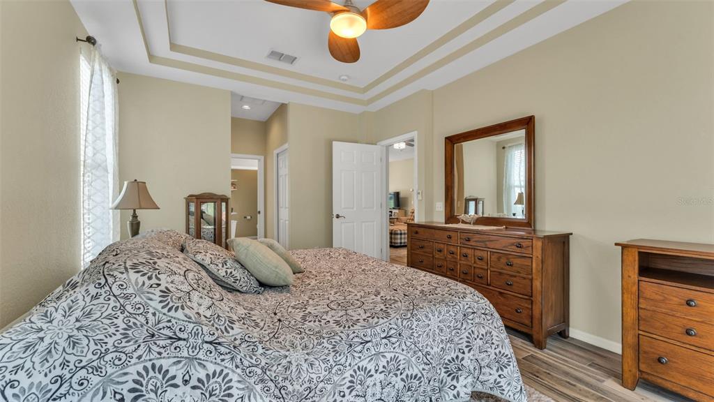 2803 Spring Meadow Drive Plant City, FL 33566 - Photo 28 of 74 a bedroom with a bed and dresser with mirror