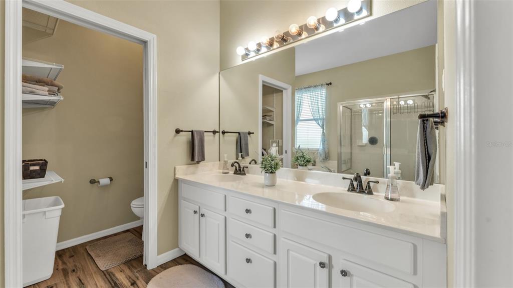 2803 Spring Meadow Drive Plant City, FL 33566 - Photo 33 of 74 a bathroom with a double vanity sink a toilet and a mirror