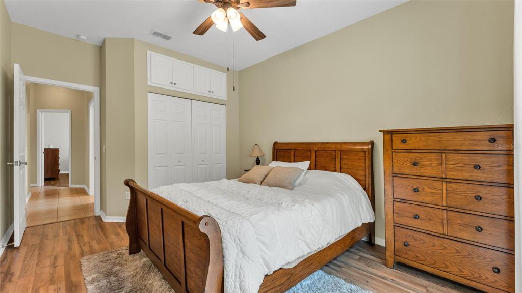 2803 Spring Meadow Drive Plant City, FL 33566 - Photo 37 of 74 a bedroom with a bed and a chandelier