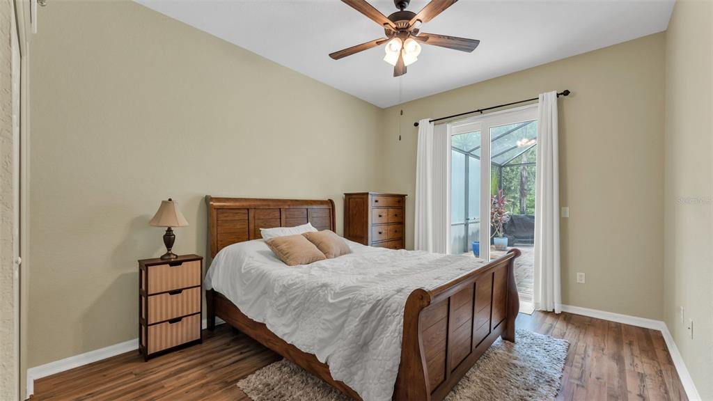 2803 Spring Meadow Drive Plant City, FL 33566 - Photo 38 of 74 a bedroom with a bed and wooden floor