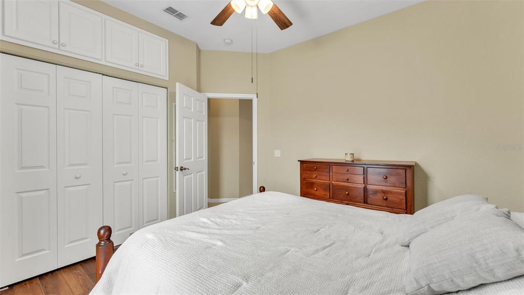 2803 Spring Meadow Drive Plant City, FL 33566 - Photo 39 of 74 a bedroom with a bed and a chandelier