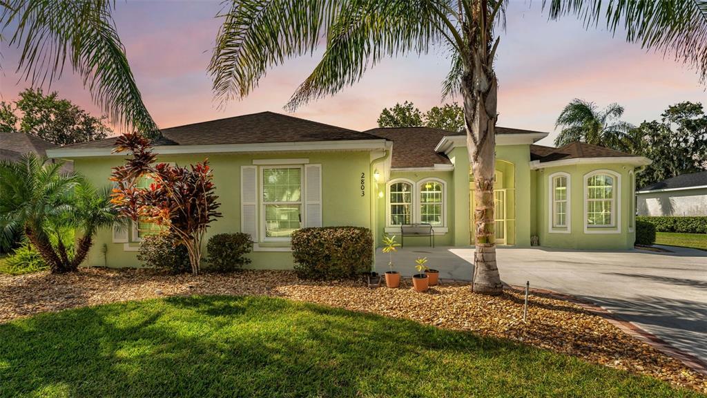 2803 Spring Meadow Drive Plant City, FL 33566 - Photo 4 of 74 a front view of a house with garden