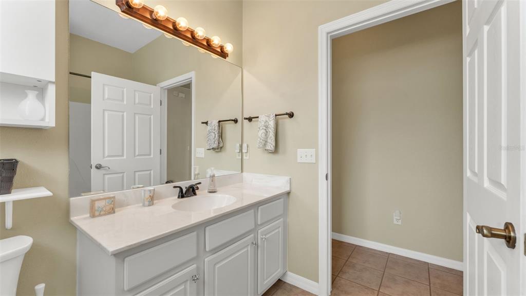 2803 Spring Meadow Drive Plant City, FL 33566 - Photo 41 of 74 a bathroom with a sink and a mirror