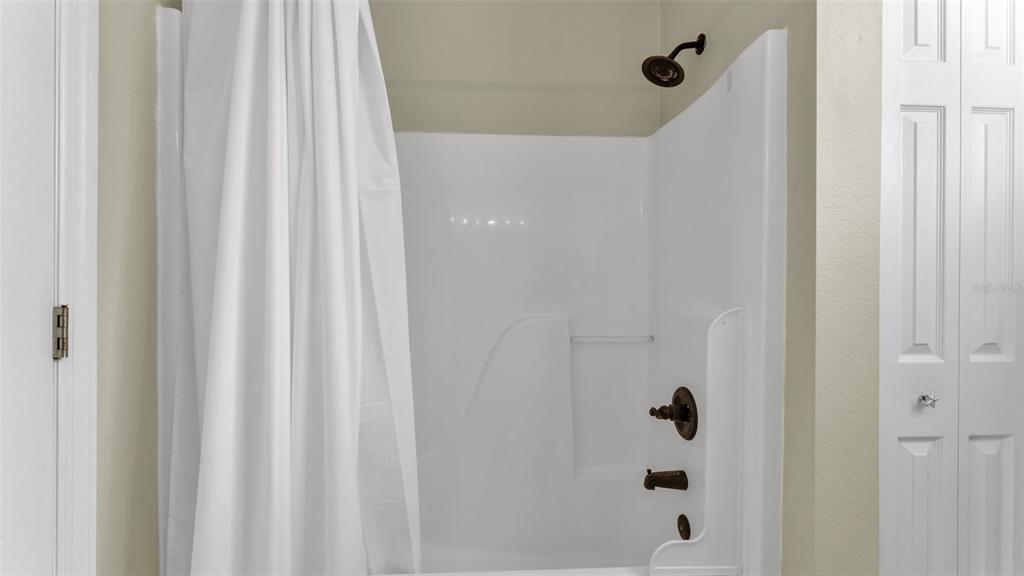 2803 Spring Meadow Drive Plant City, FL 33566 - Photo 42 of 74 a bathroom with a shower and a window curtain