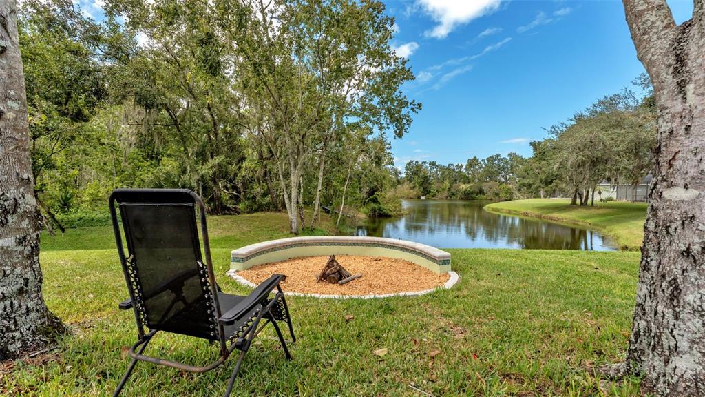 2803 Spring Meadow Drive Plant City, FL 33566 - Photo 64 of 74 a view of a swimming pool with a table and chairs