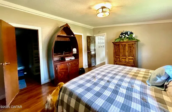 a bedroom with a bed and a dresser