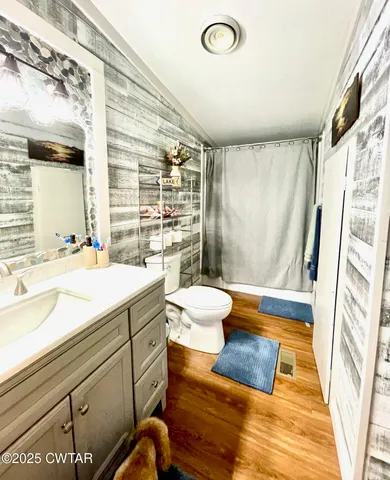 a bathroom with a sink a mirror and a shower