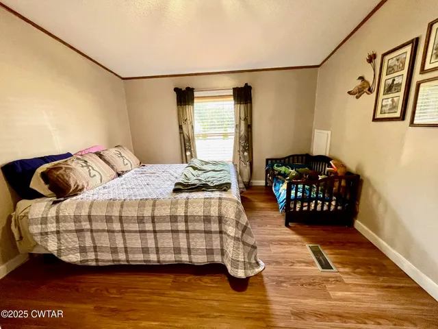 a bedroom with a bed and a couch