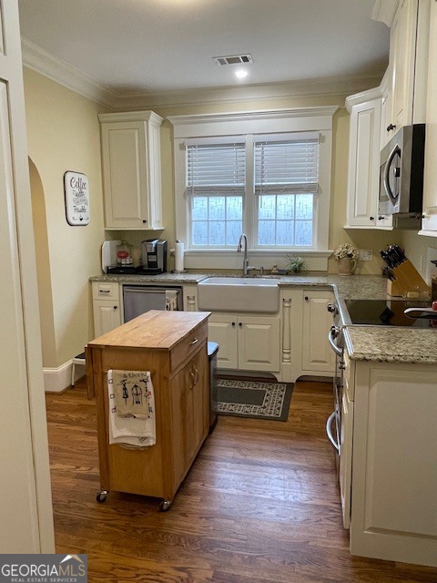 311 3rd Street Manchester, GA 31816 - Photo 22 of 62 a kitchen with a stove sink and cabinets