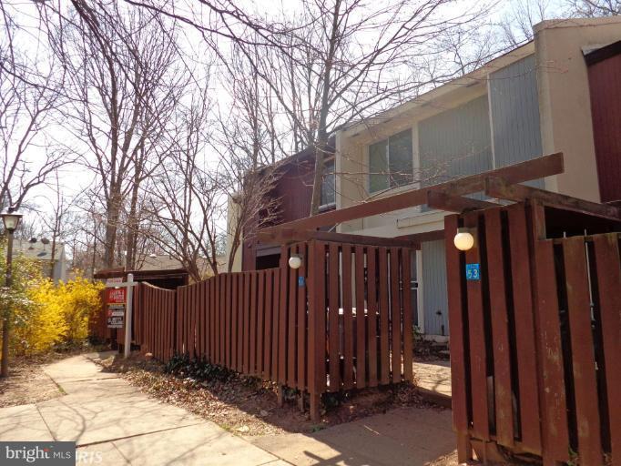 2249 Southgate Square Reston, VA 20191 - Photo 1 of 6 a view of a house with a wooden fence