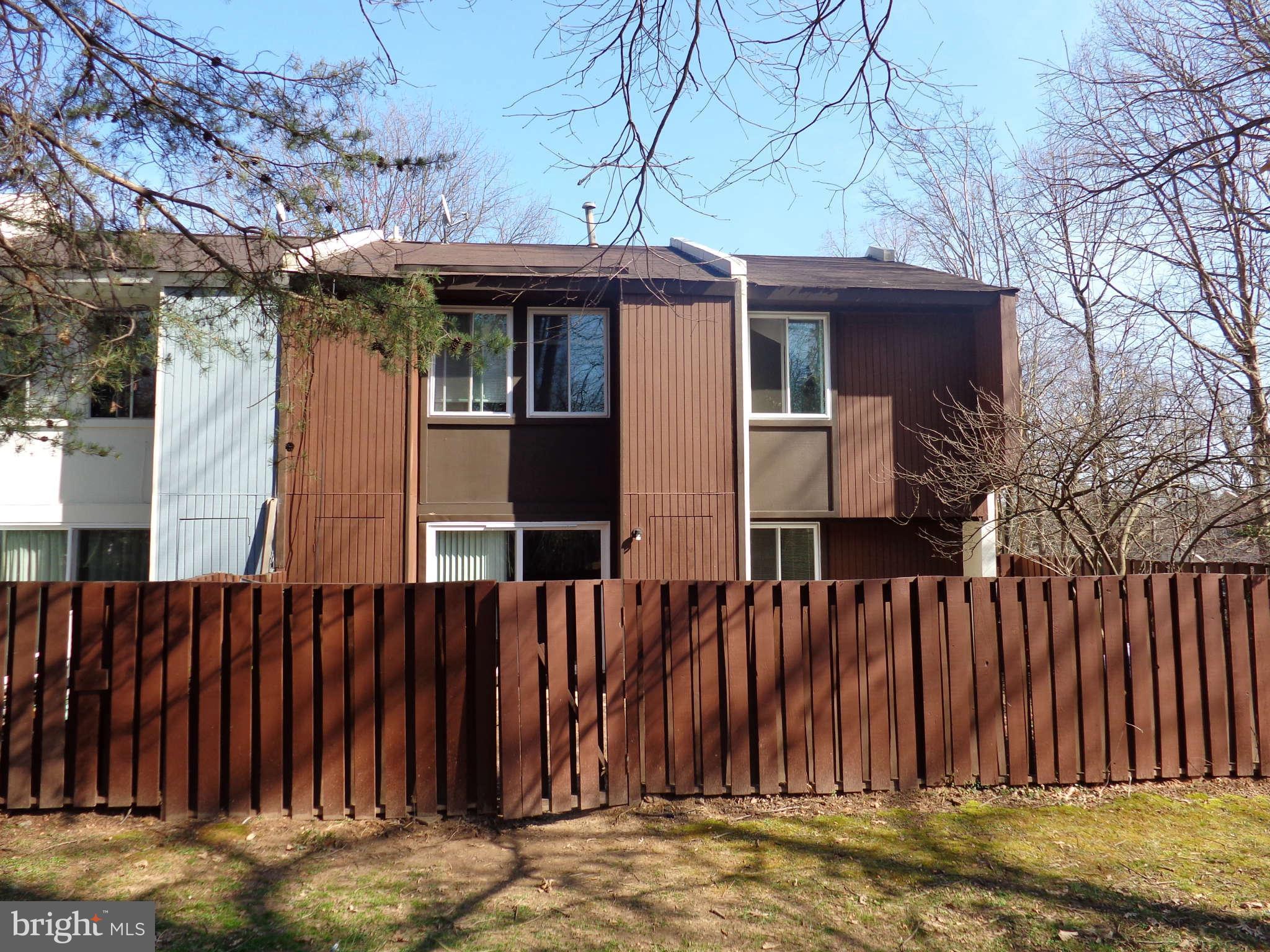 2249 Southgate Square Reston, VA 20191 - Photo 6 of 6 a view of a house with a wooden fence