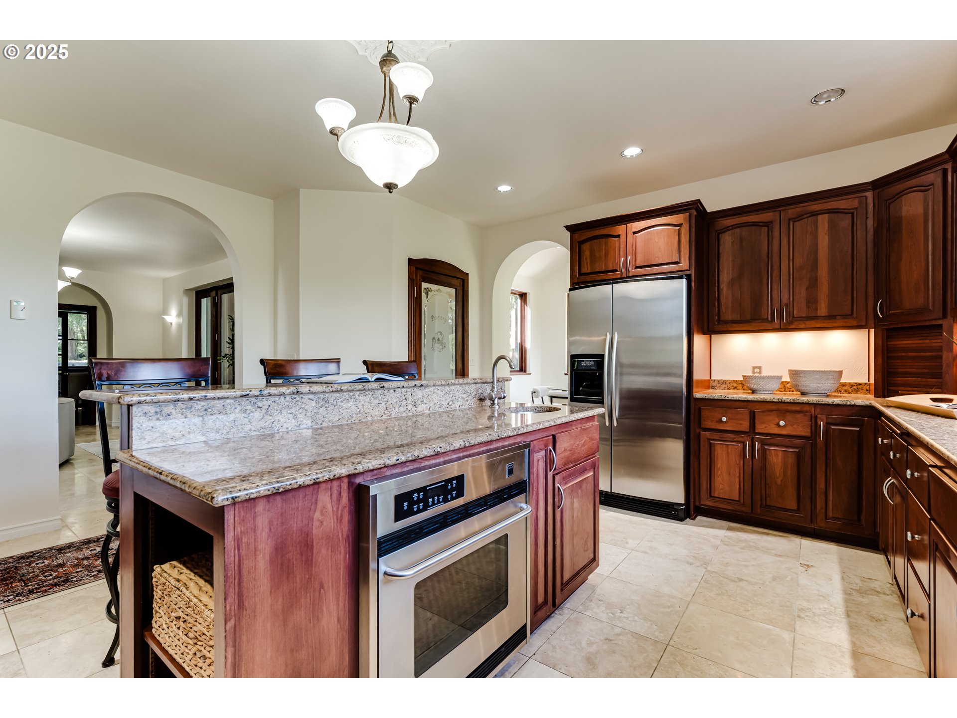 27161 Briggs Hill Road Eugene, OR 97405 - Photo 16 of 47 a kitchen with stainless steel appliances kitchen island granite countertop a stove refrigerator and cabinets