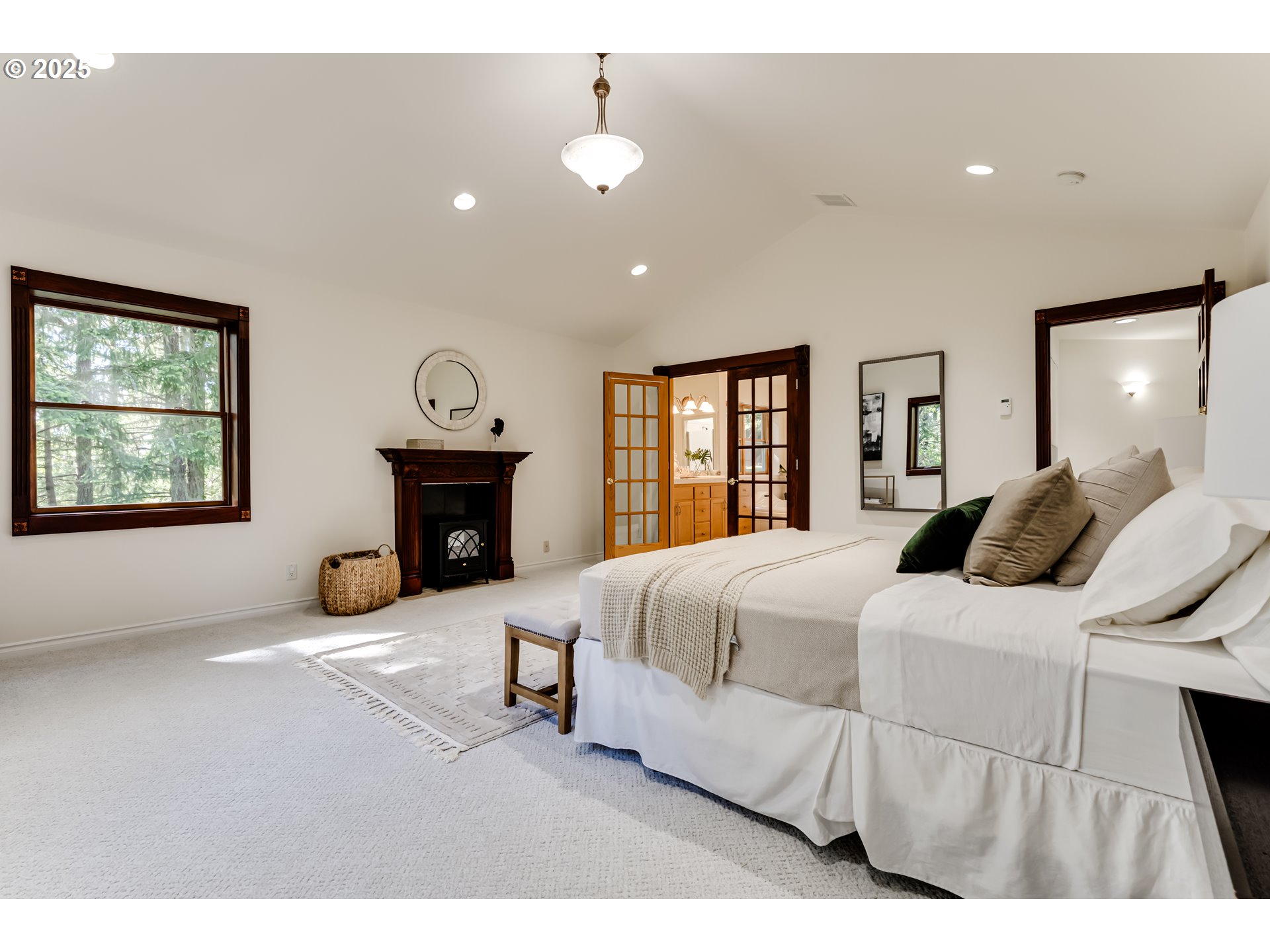 27161 Briggs Hill Road Eugene, OR 97405 - Photo 25 of 47 a spacious bedroom with a bed and a fireplace