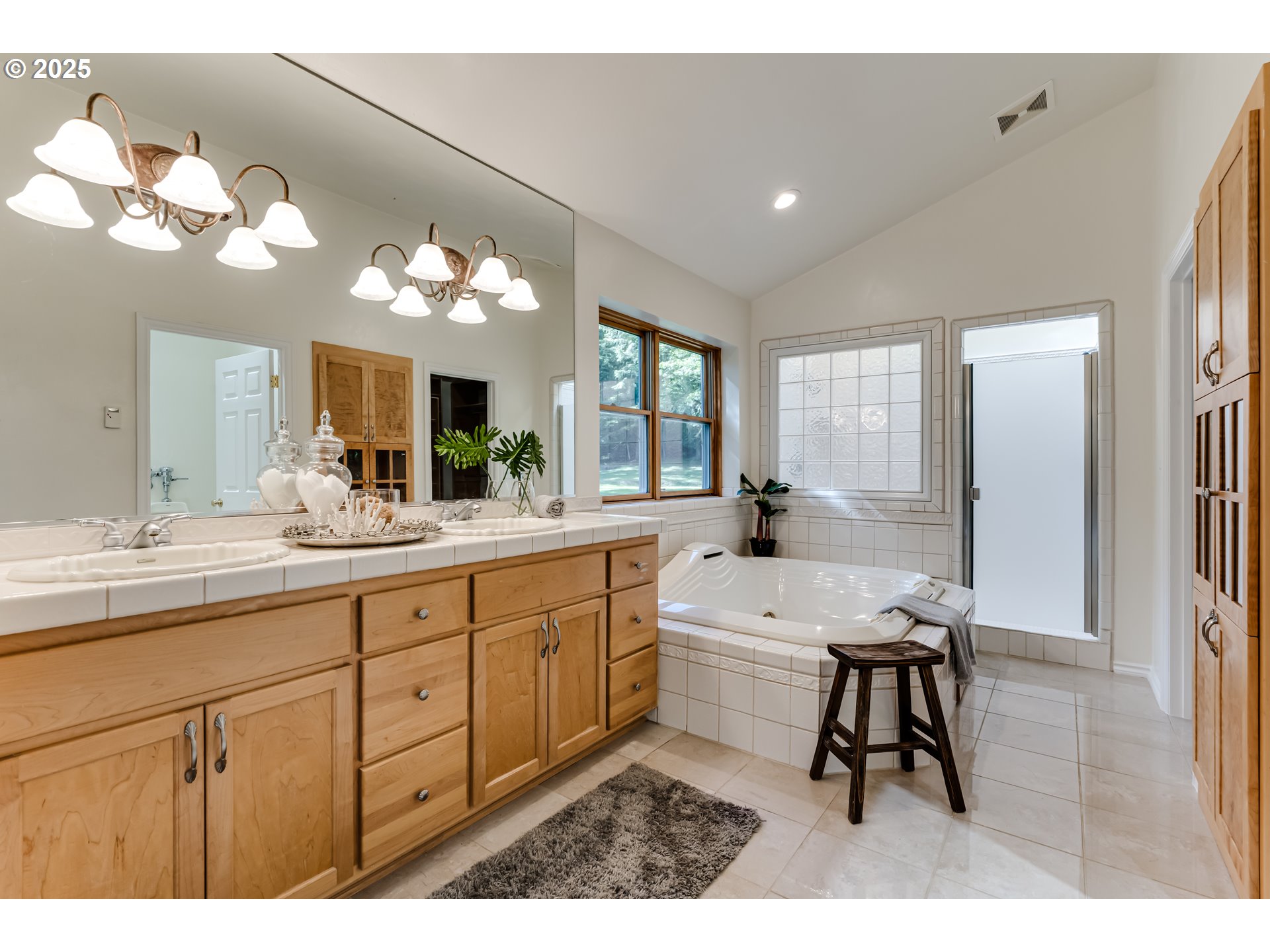 27161 Briggs Hill Road Eugene, OR 97405 - Photo 27 of 47 a spacious bathroom with a double vanity sink a mirror and a bathtub