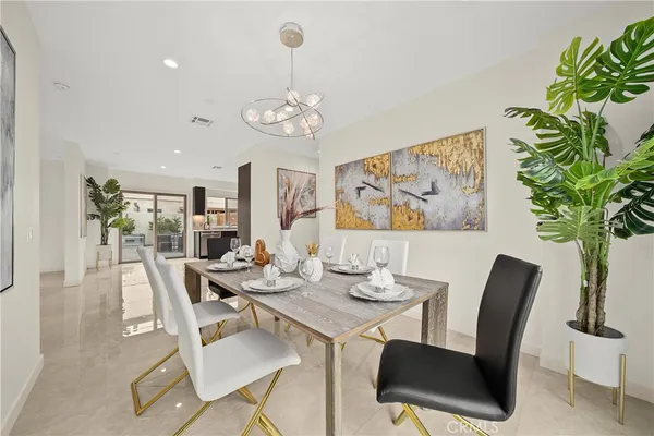 a view of a dining room with furniture wooden floor and a chandelier