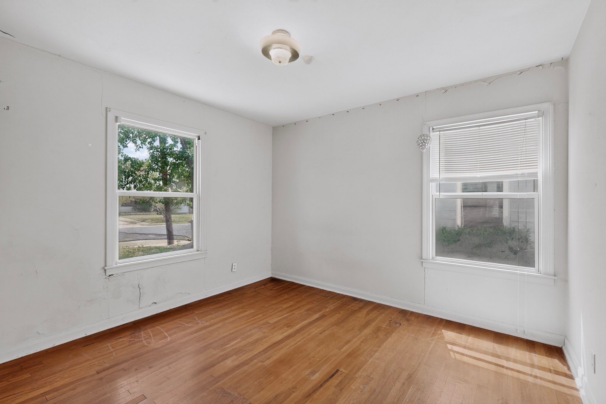 4703 Leslie Avenue Austin, TX 78721 - Photo 12 of 34 Hardwood flooring extends through this naturally illuminated room with dual windows.