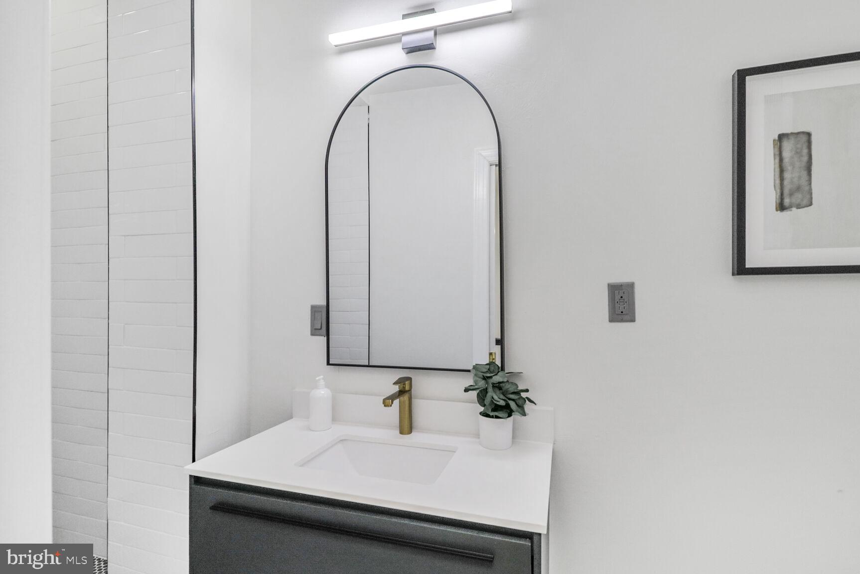 226 South Madeira Street Baltimore, MD 21231 - Photo 15 of 21 a bathroom with a sink and a mirror