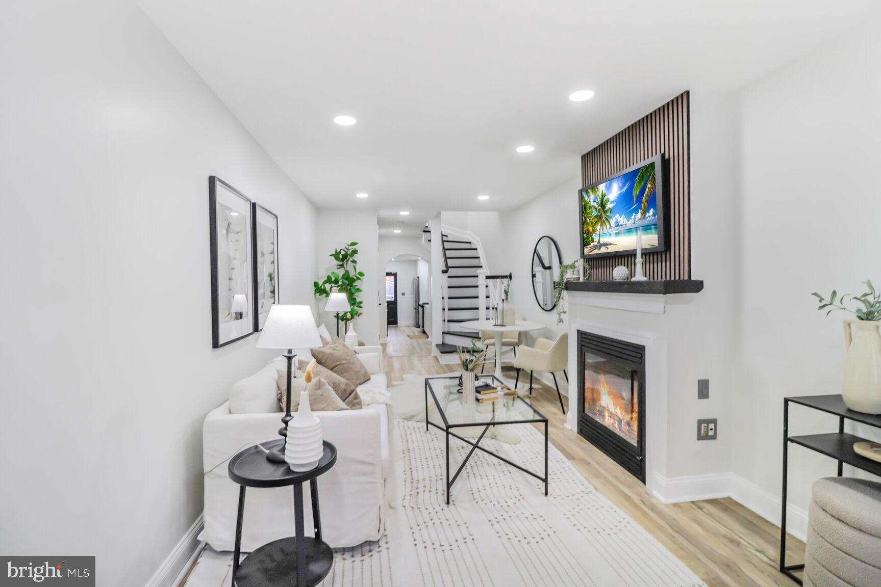 226 South Madeira Street Baltimore, MD 21231 - Photo 3 of 21 a living room with fireplace furniture and a flat screen tv