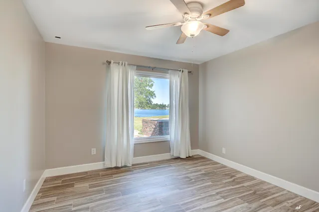 wooden floor in an empty room with a window