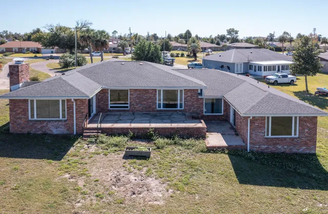 a view of a house with a yard and sitting area