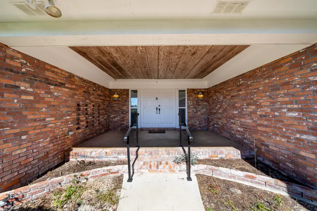 an aerial view of a house with yard