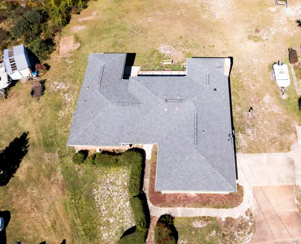 an aerial view of a houses with a parking space