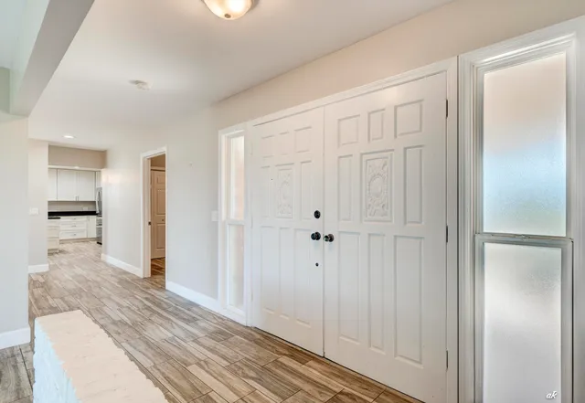 a view of a hallway with wooden floor