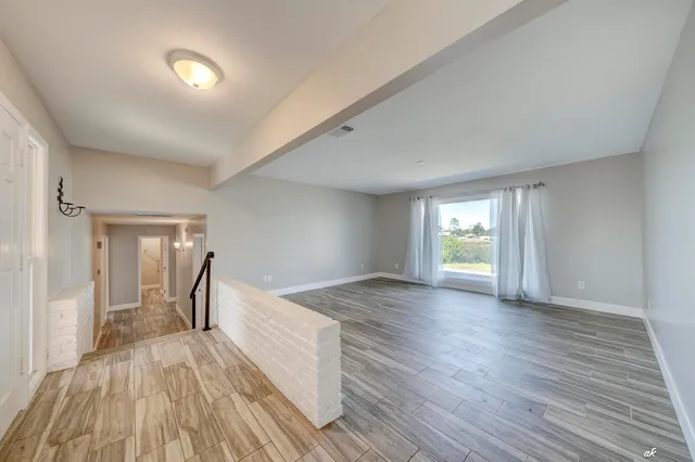 a kitchen with stainless steel appliances granite countertop a refrigerator a sink and white cabinets