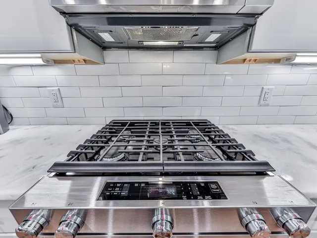 a stove sitting inside of a kitchen