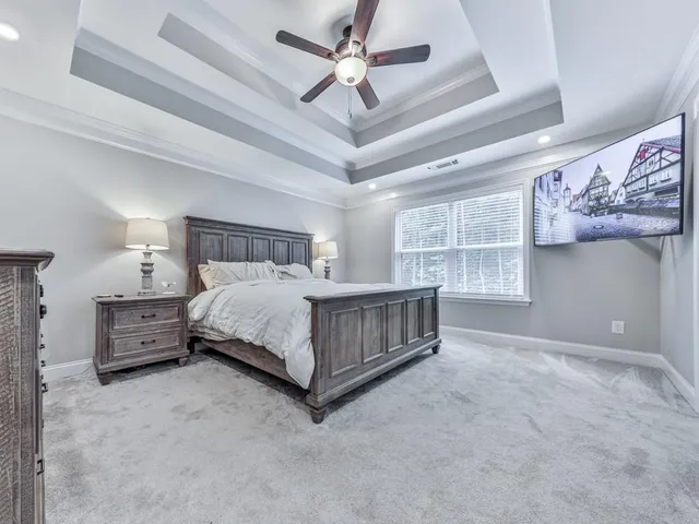a bedroom with a bed and a ceiling fan