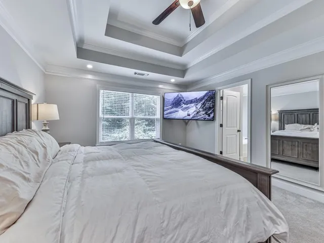 a bedroom with a large bed and a window