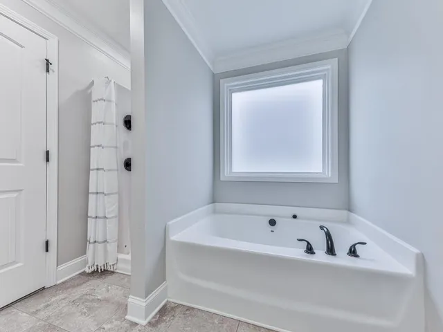 a white bath tub sitting next to a window
