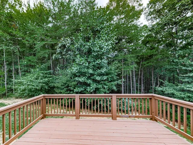 a view of balcony with deck and trees