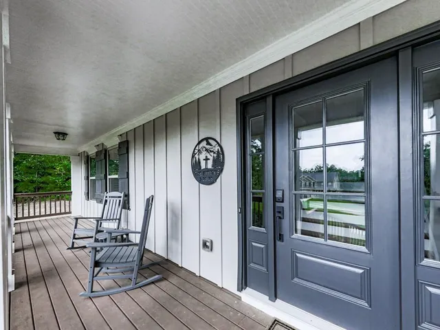 a view of a house with backyard and porch