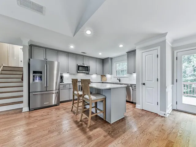 a kitchen with a sink appliances and cabinets