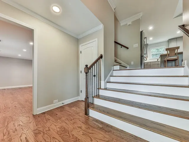 a view of entryway and hall with wooden floor